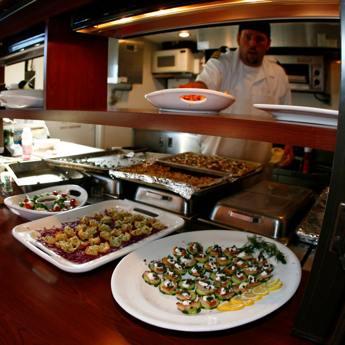 A chef prepares food on the Tahoe Gal